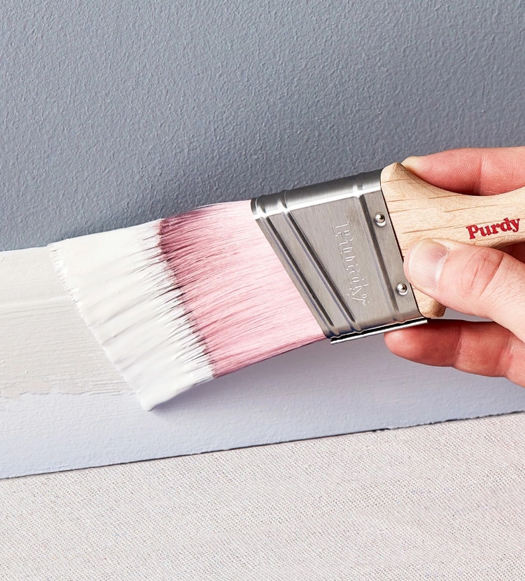 Pro painting a baseboard