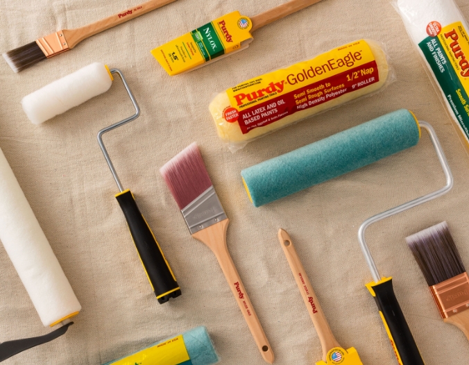 Various Purdy painting tools on drop cloth.