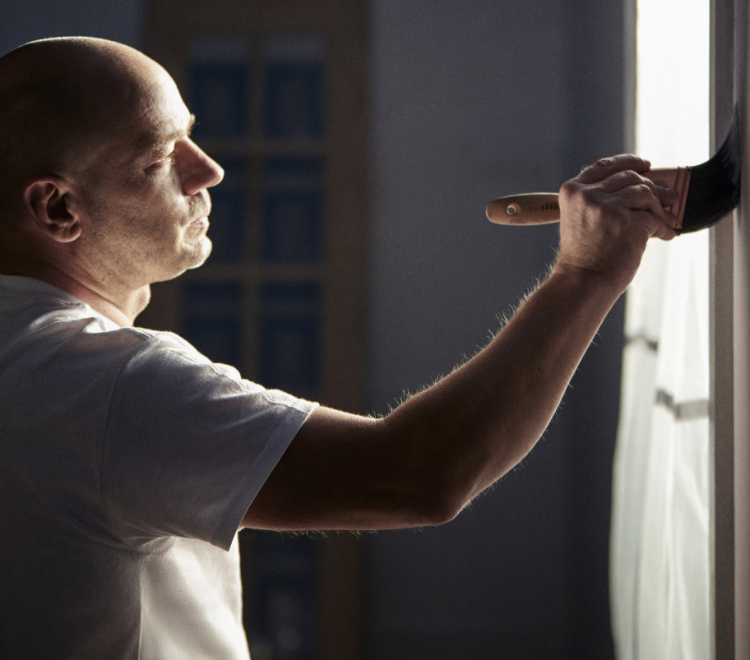 person painting a wall