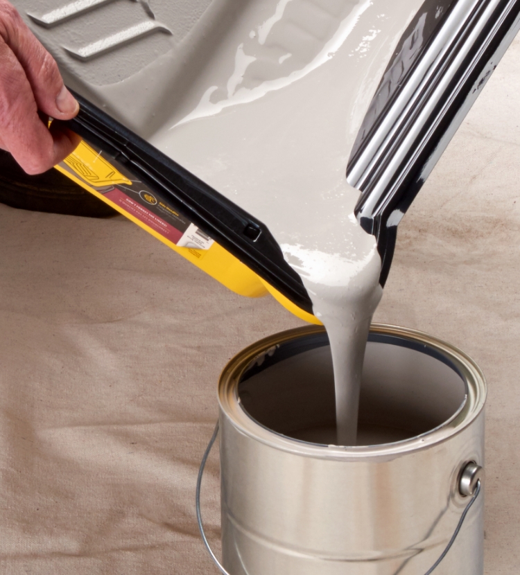 Pro painter pouring paint back into a can from a Nest tray using a pour spout.
