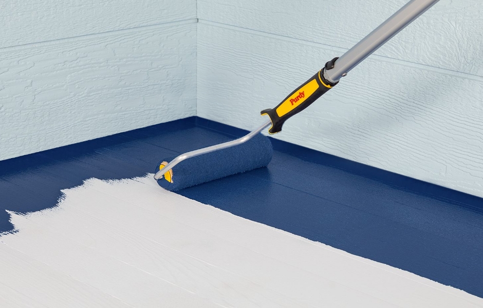 Pro painting a floor with a Purdy roller