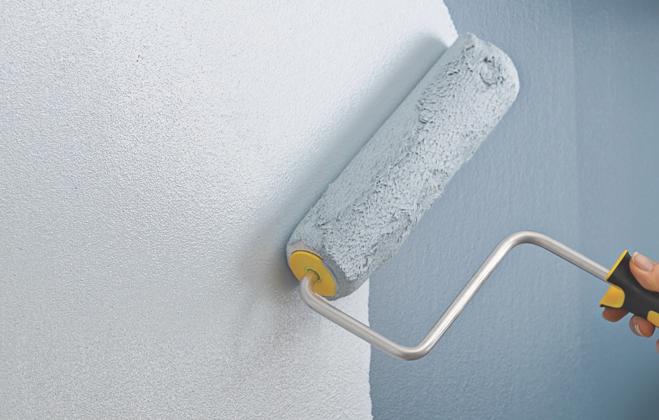 Profesional pintando una pared con un rodillo Purdy