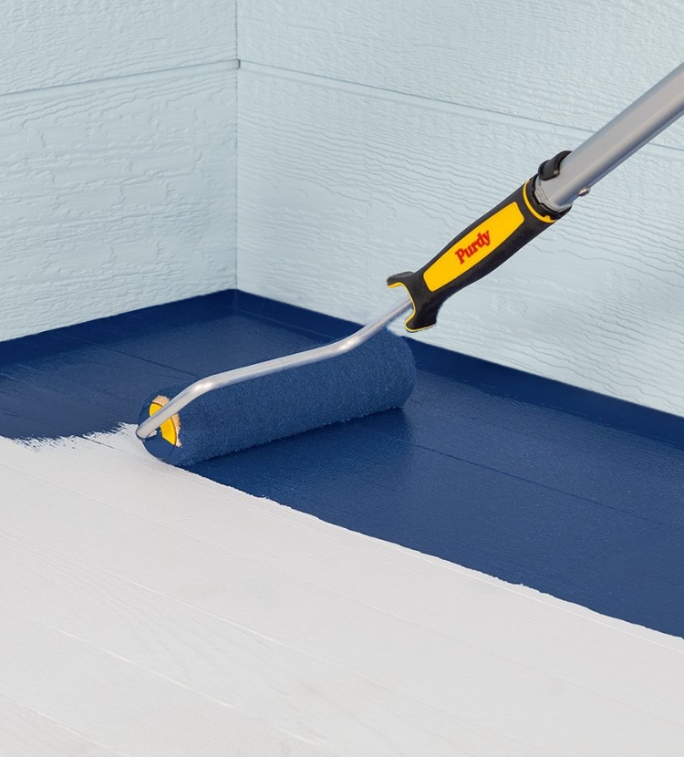 Pro painting a floor with a Purdy roller