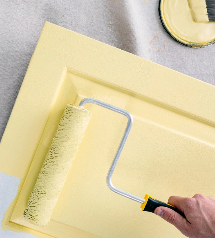 Purdy roller painting a door yellow