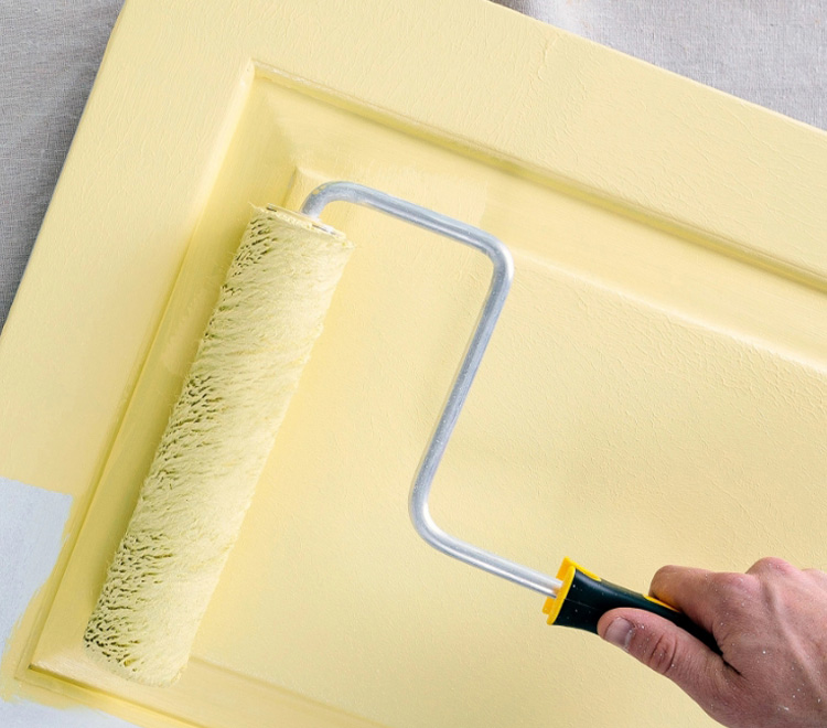 Purdy roller painting a door yellow