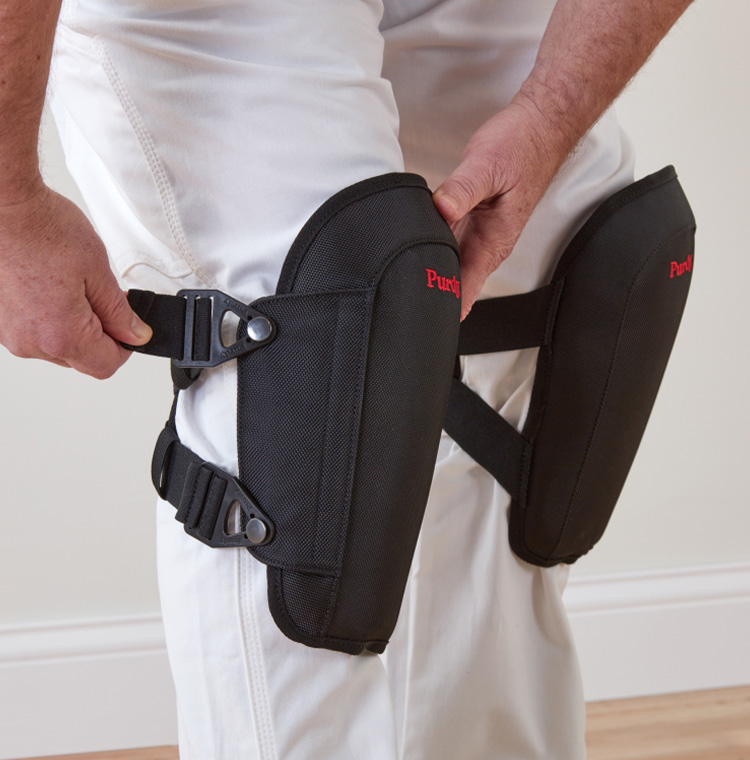 painter putting on knee pads
