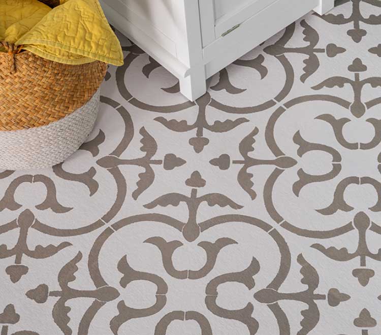 Detail of a stenciled concrete floor with gray and white design.
