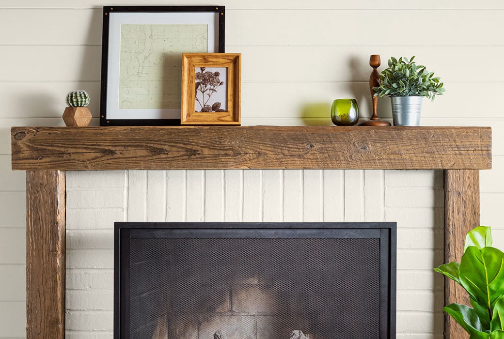 Beautiful painted white brick fireplace with a rustic wood mantle.