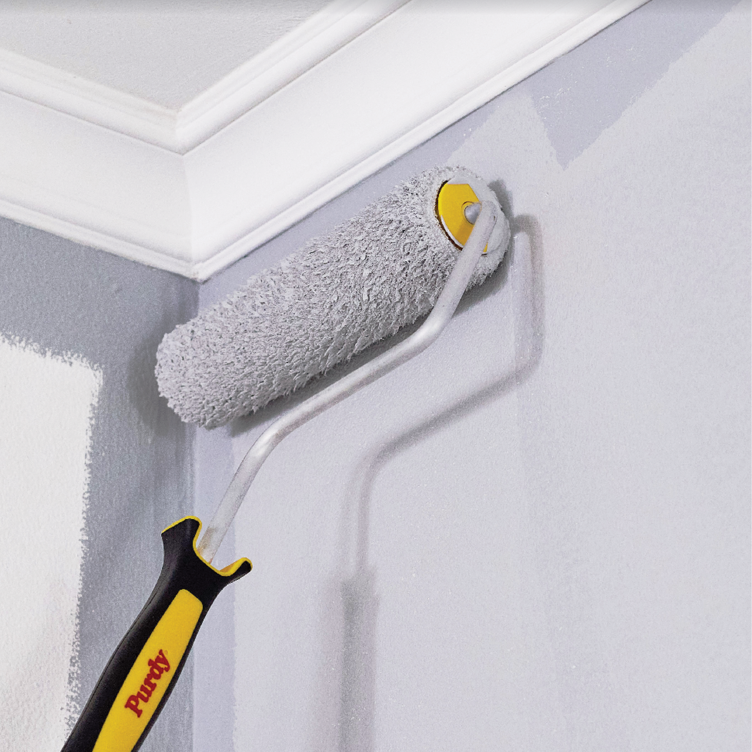 using a Purdy Altitude roller to apply paint to a wall