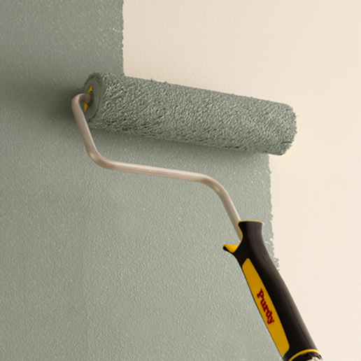 Using a Purdy roller and cover to paint a wall.