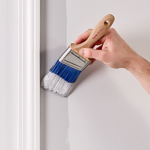 applying paint to a wall