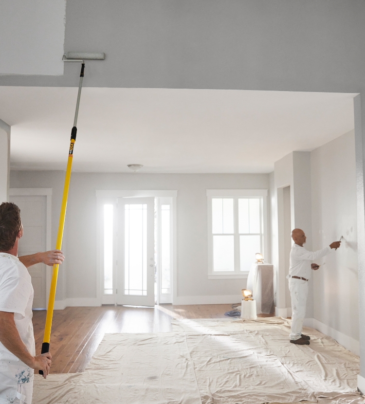 Painters using Purdy rollers, roller frames and extension poles to paint a wall.