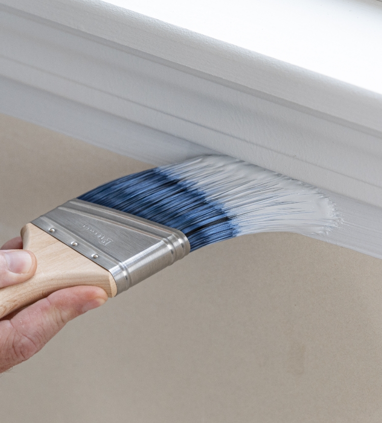 Painting under the window frame with a Pro-extra brush, creating a sharp line.